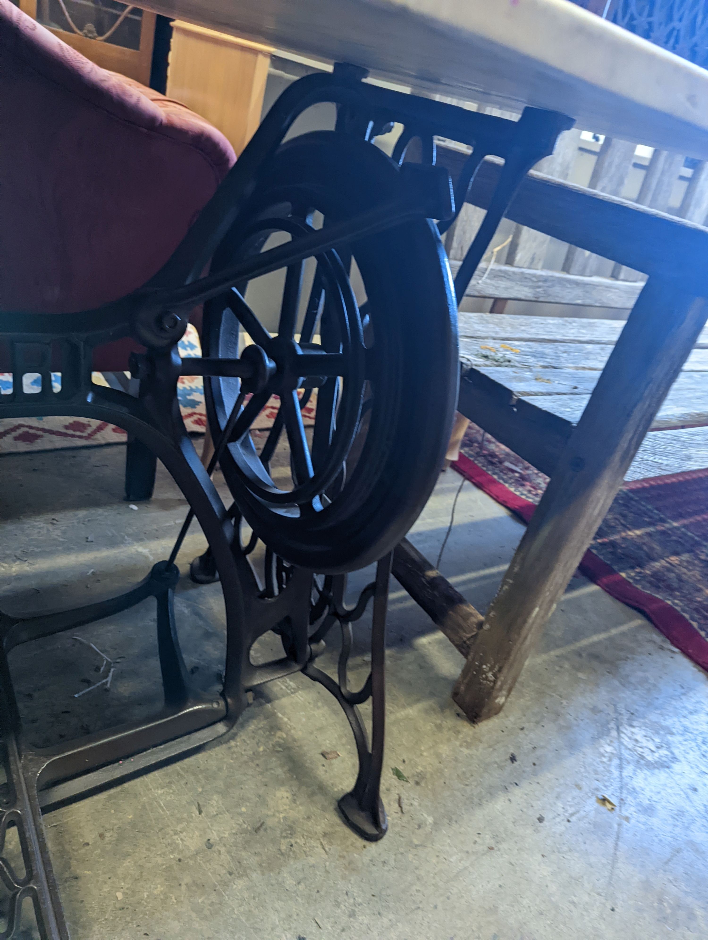 A Singer sewing machine treadle base with later marble top, width 130cm, depth 70cm, height 76cm